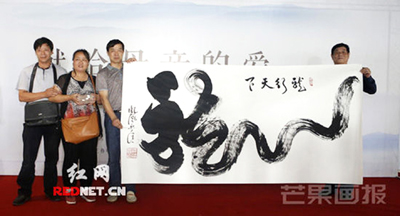 胡世杰父母（左二）与书法家谭贵请及拍出作品留影